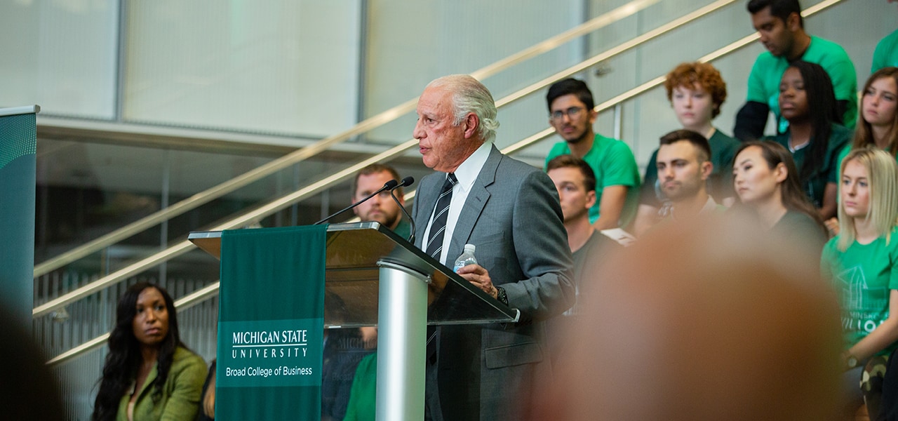 Edward J. Minskoff standing at a podium, speaking at the Minskoff Pavilion ribbon cutting ceremony.