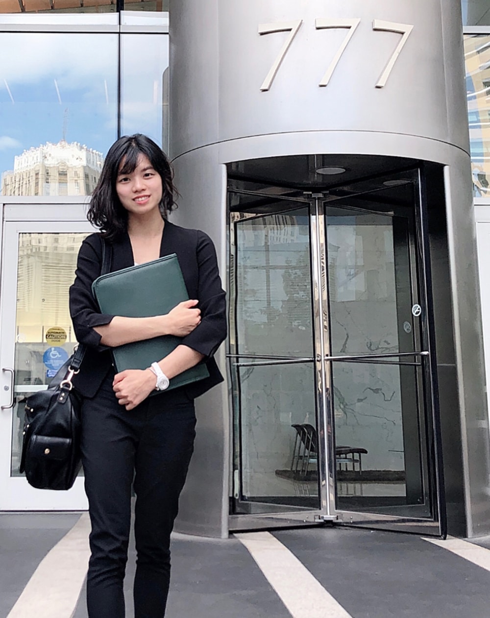 M.S. in Accounting student Daisy Wu pictured in professional attire outside of an office building.