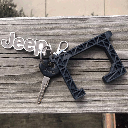 A black version of the Spartan-designed No-Touch Tool attached to a set of Jeep car keys as a keychain.